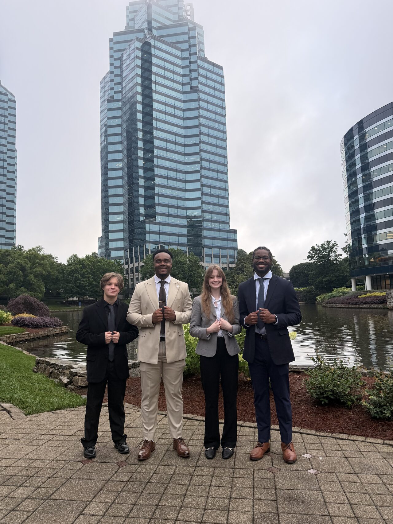 Noble Impact Marketing team of professionals standing together outside a corporate office