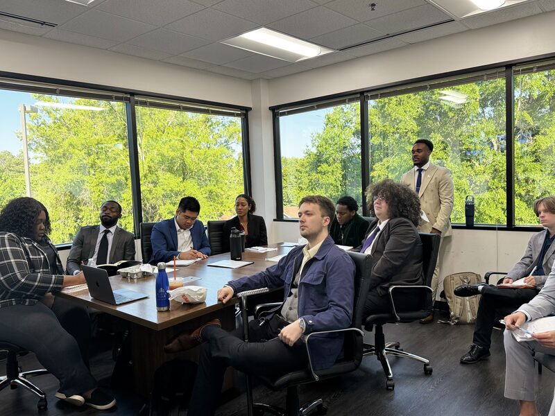 Noble Impact Marketing team collaborating in a bright conference room meeting